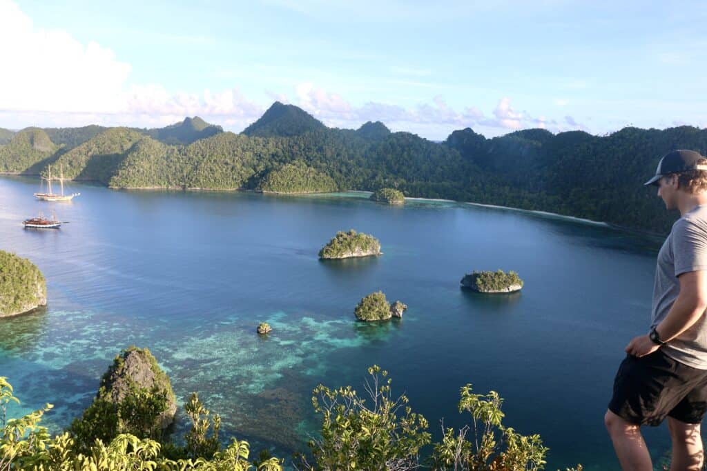 traveler admires view during Raja Ampat snorkeling trip
