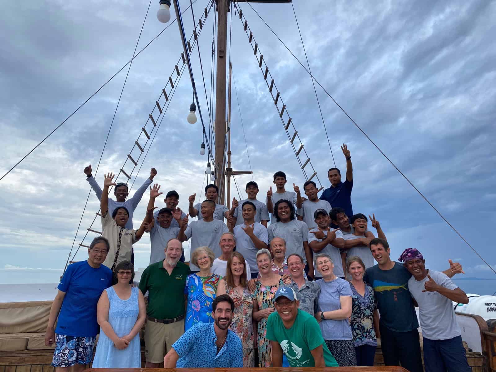 group travelers posing on liveaboard ship in Raja Ampat Indonesia