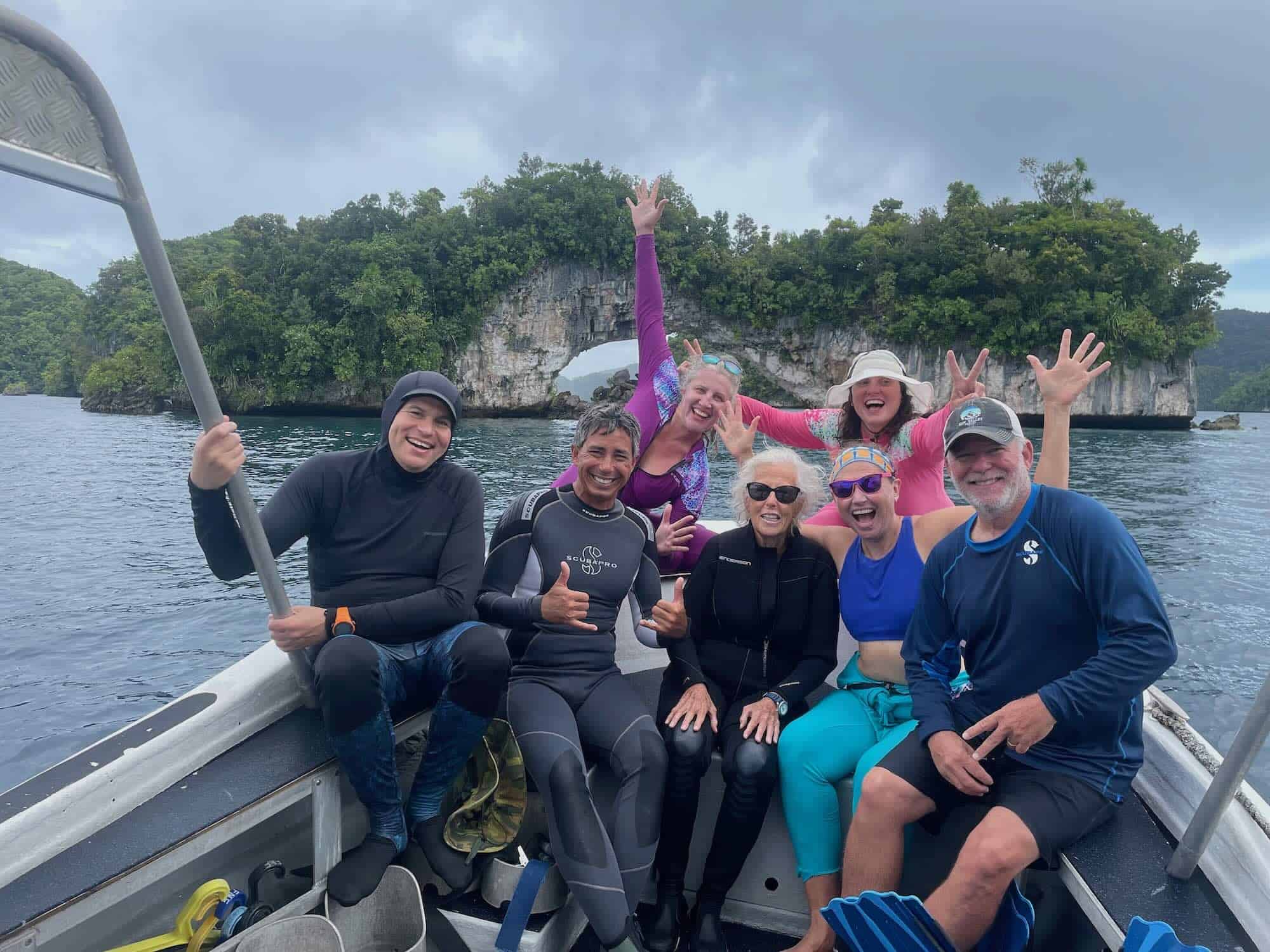 travelers pose on a boat in Palau