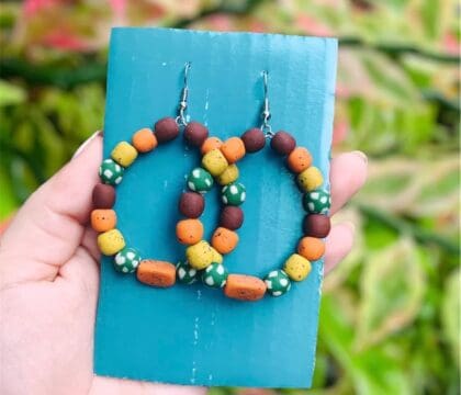 Handmade Palauan products, including polymer clay earrings and eco-friendly lip balms, supporting local artisans and ocean conservation.